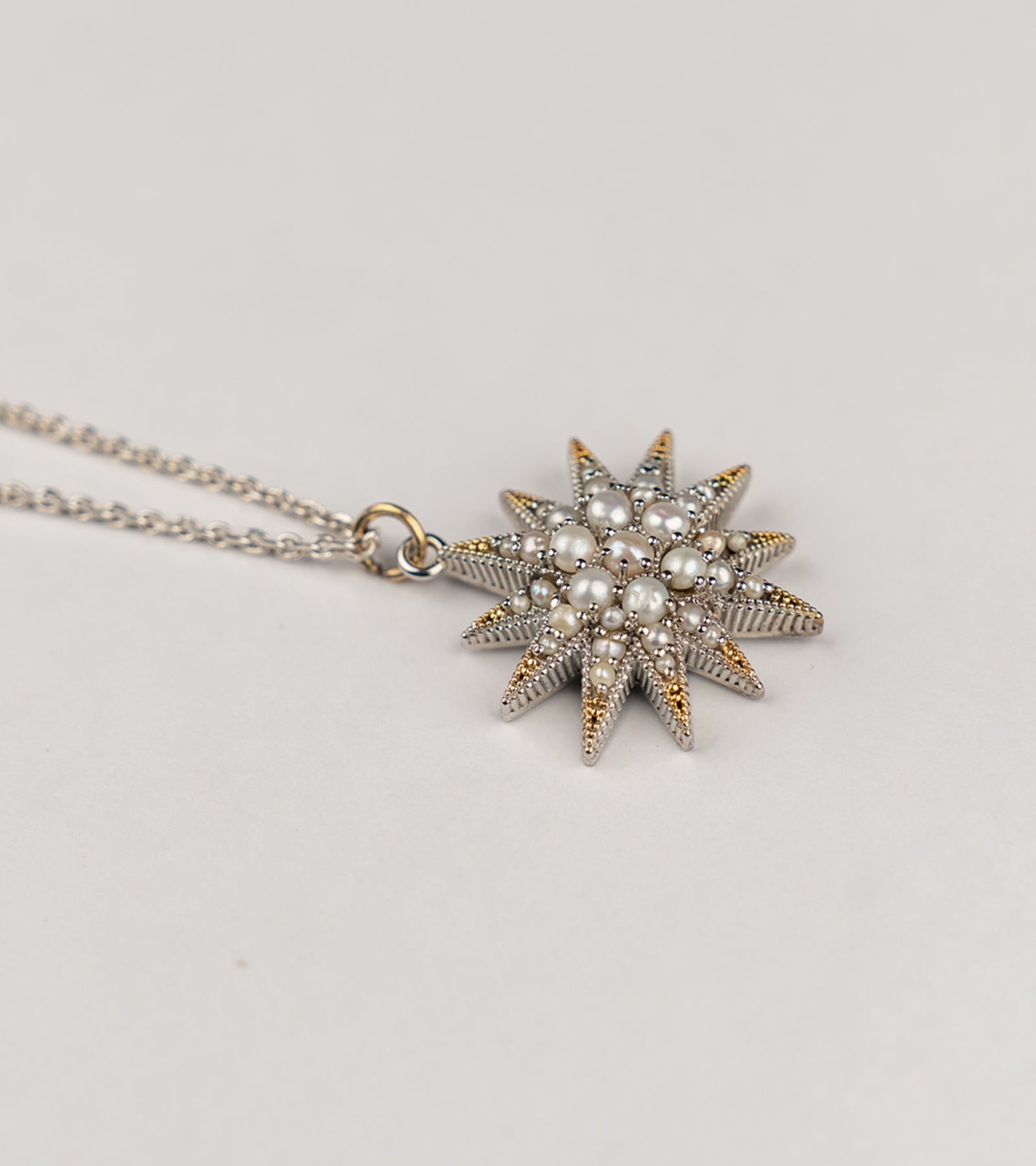 Nova Necklace with a starburst-inspired silhouette handcrafted in sterling silver, adorned with luminous Japanese pearls
