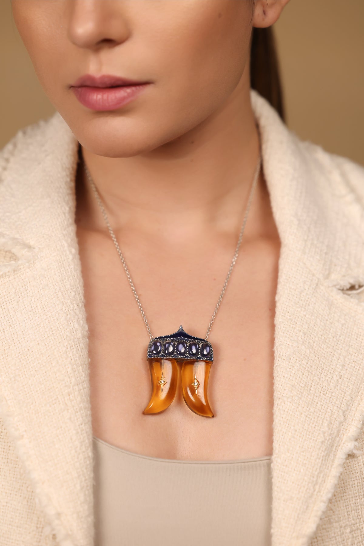 Close-up of the Rio Pendant showing the crafted kyanite and topaz stones set within the double Vagh Nakh silhouette
