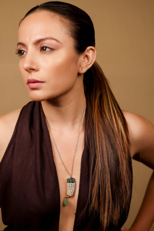 Sage Pendant worn as a statement piece, layered with delicate silver chains