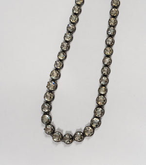 Detail shot of the Swati Necklace showing the silver setting and continuous line of citrine stones
