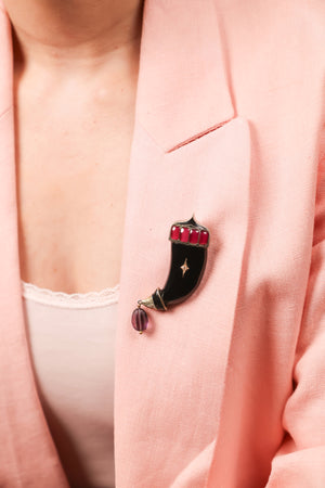 Close-up of the tiger silhouette and black onyx detailing on the Tiger Brooch