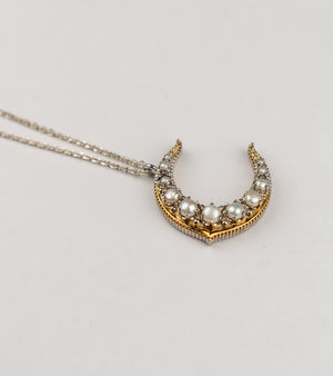 Tsuki Necklace with an elegant crescent silhouette handcrafted in sterling silver, adorned with luminous Japanese pearls