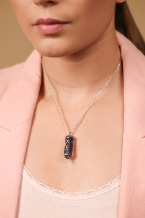 Vega Pendant worn against an elegant neckline, taking the spotlight of the look