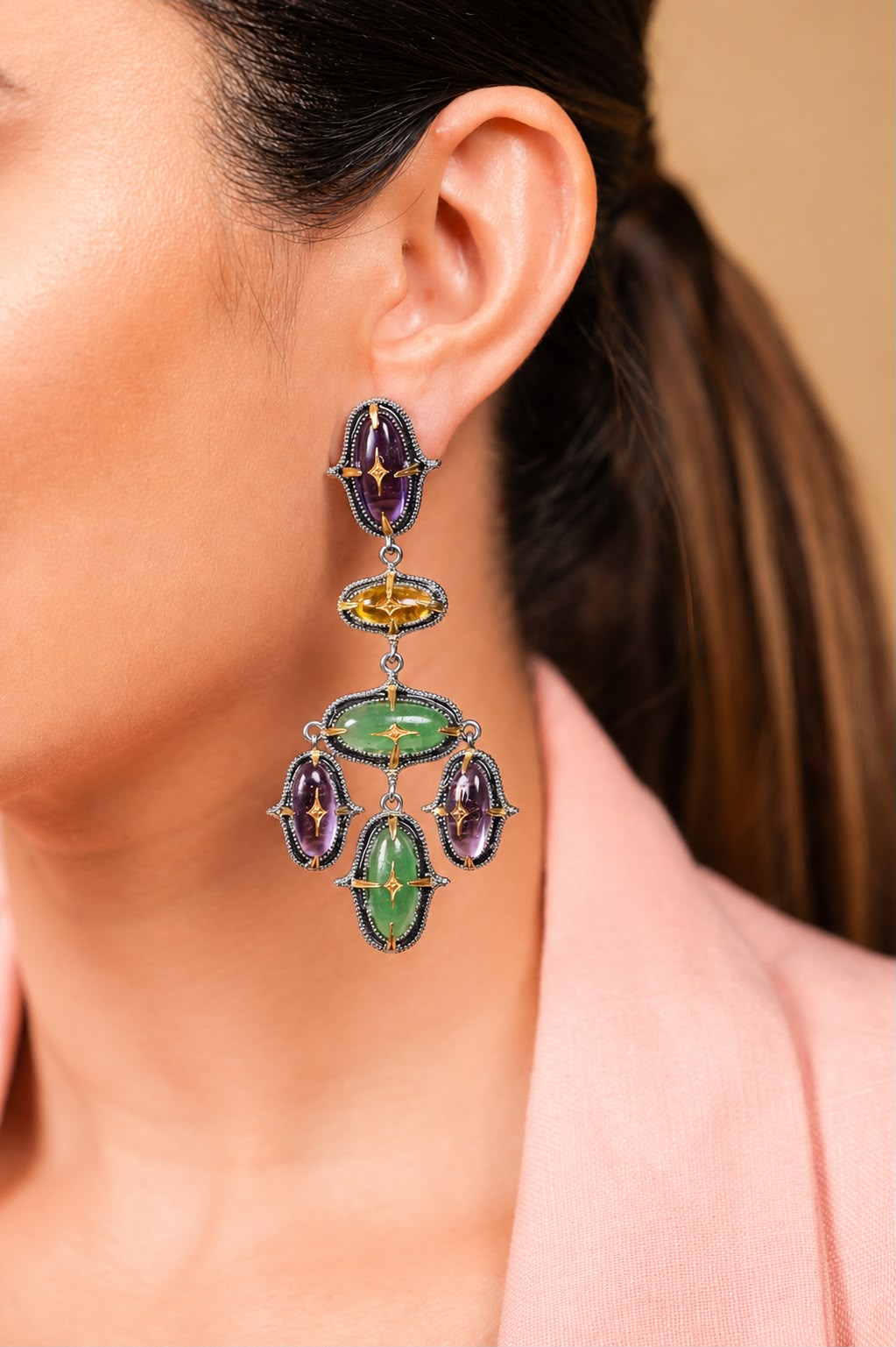 Close-up of the silver milgrain settings and gold star motifs on the Aarya Earrings