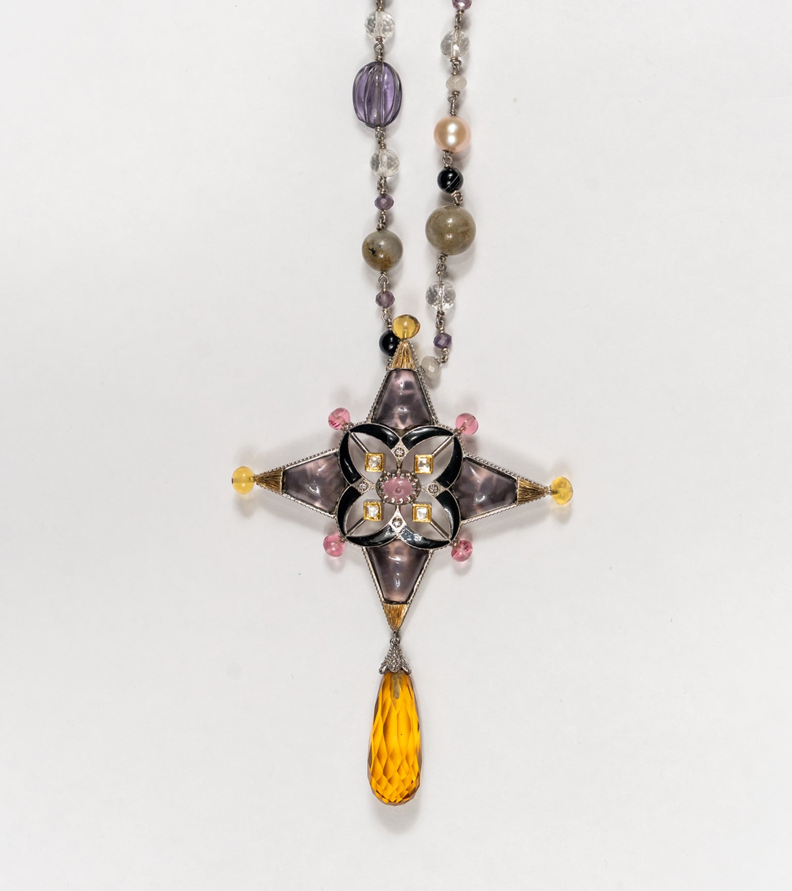 Detail of the beaded chain of pearls and natural stones on the Aashka Necklace, finishing in a topaz drop