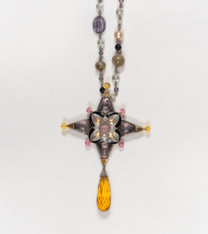 Detail of the beaded chain of pearls and natural stones on the Aashka Necklace, finishing in a topaz drop