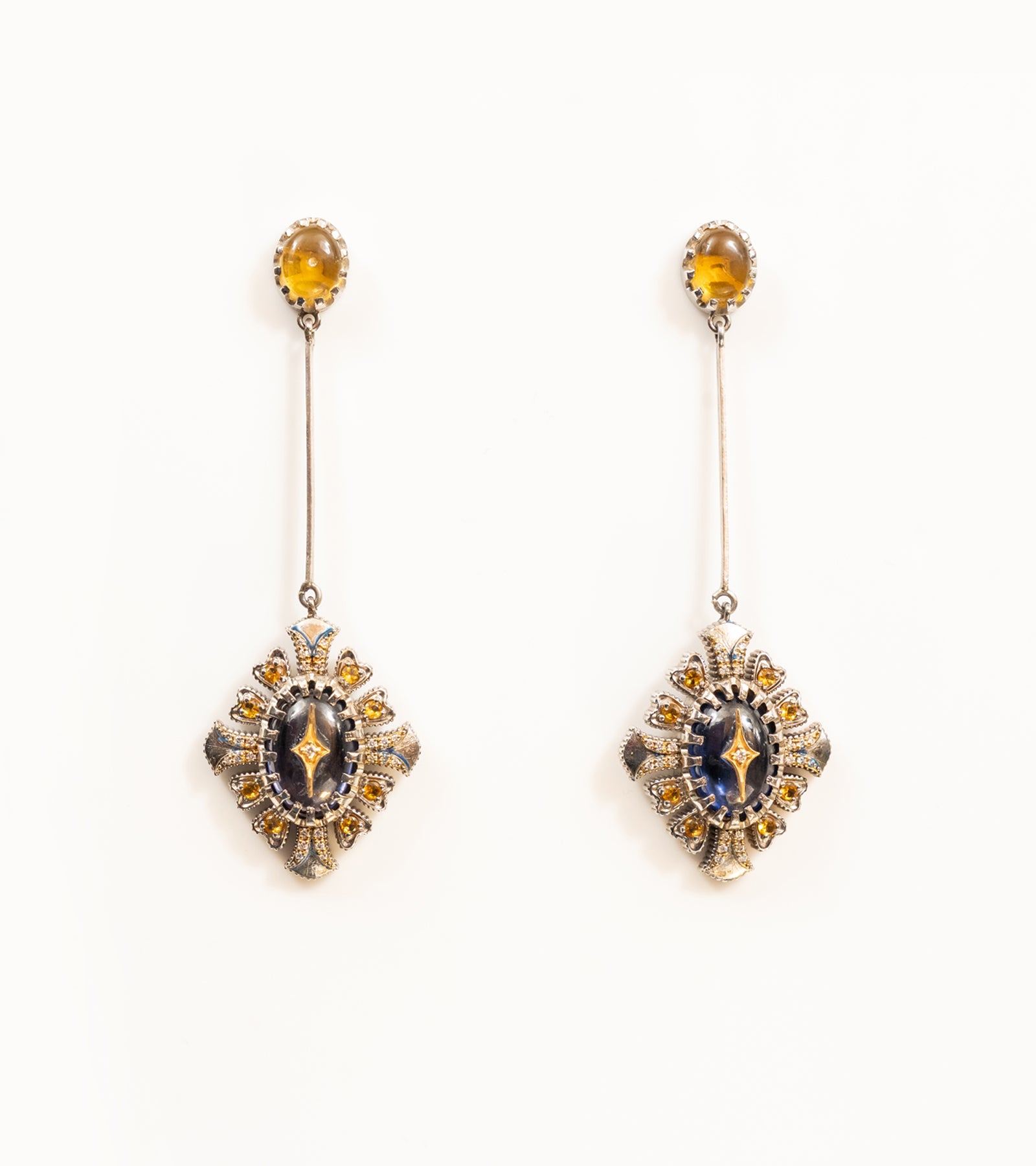 Ada Earrings with a crafted topaz stud, long silver bar, and diamond-shaped pendant in blue kyanite, topaz, and diamonds, with blue hand-painted enamel