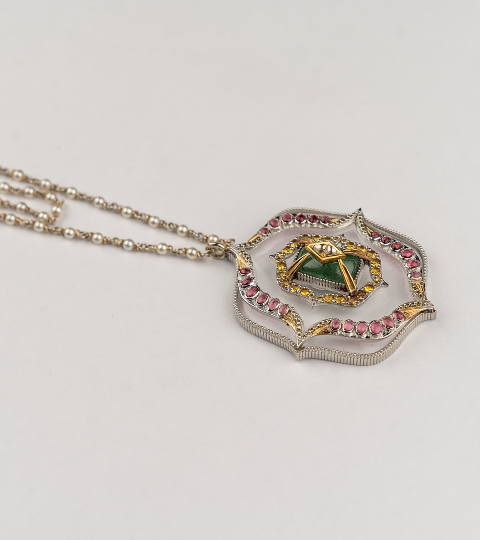 Amara Necklace with a long double strand of crafted pearls in silver wire, leading to an architectural pendant with crafted stones and a gold star motif