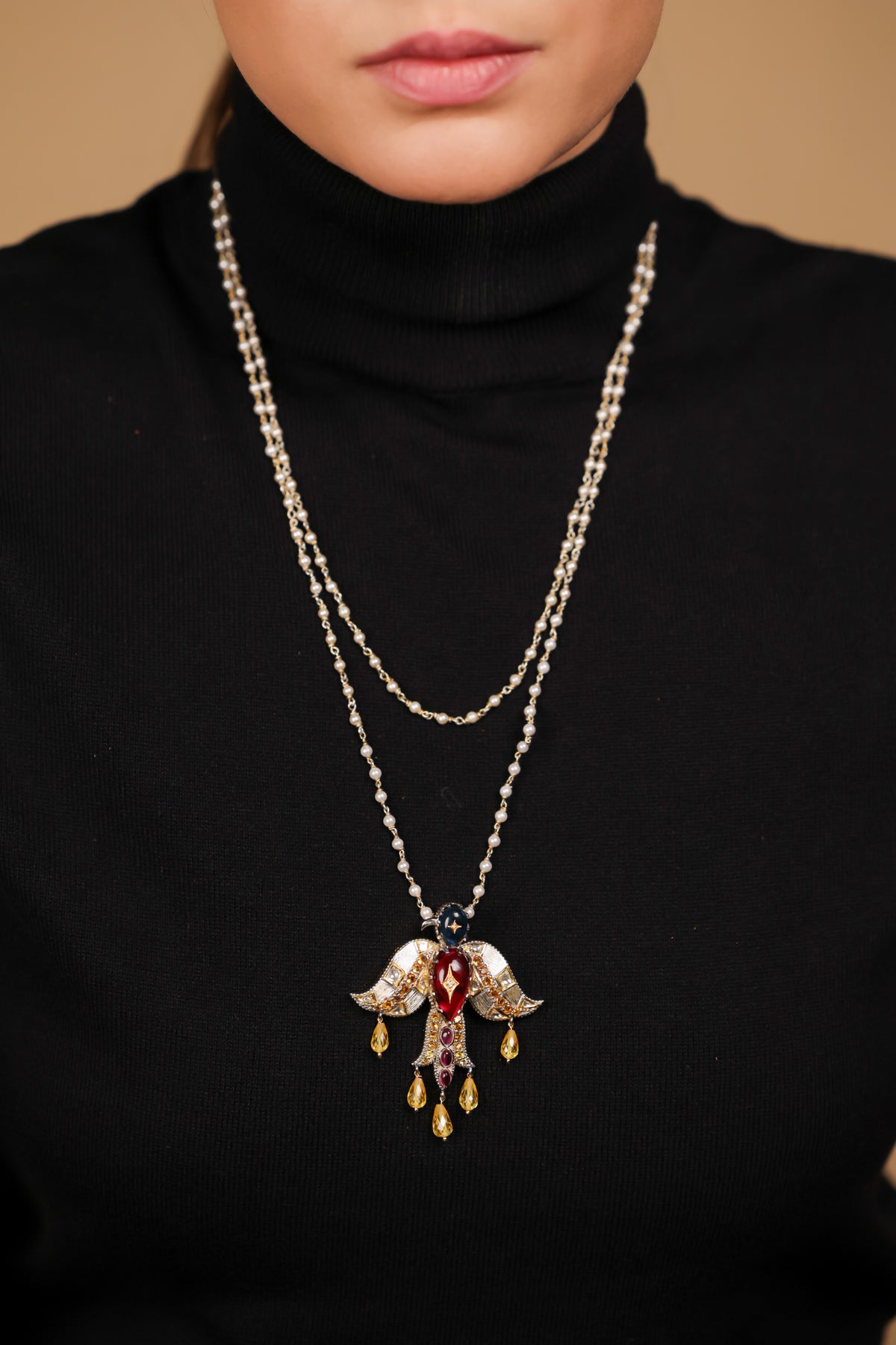Deval Necklace worn with structured tailoring, the Garuda pendant as the centrepiece