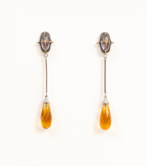 Meeti Earrings with an amethyst stud, gold star motif, long silver bar, and faceted topaz briolette drop