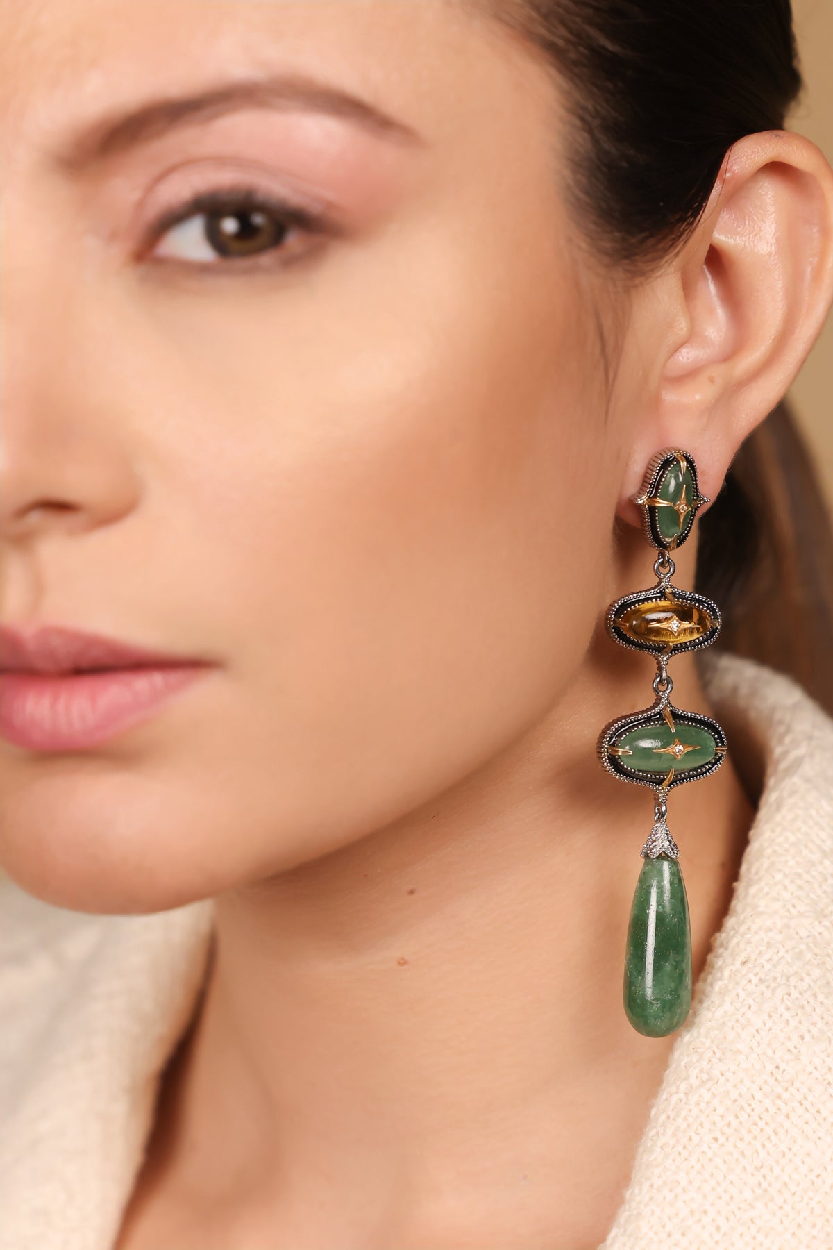 Close-up of the silver milgrain settings and gold star motifs on the Miral Danglers