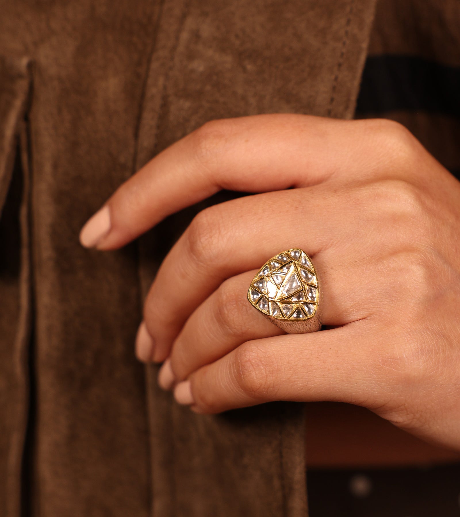 Close-up of hand-set Polki diamonds in Kundan gold on the Neo Ring's trillion silhouette