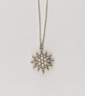 Detail of the Japanese pearls set within the Nova Necklace's silver starburst