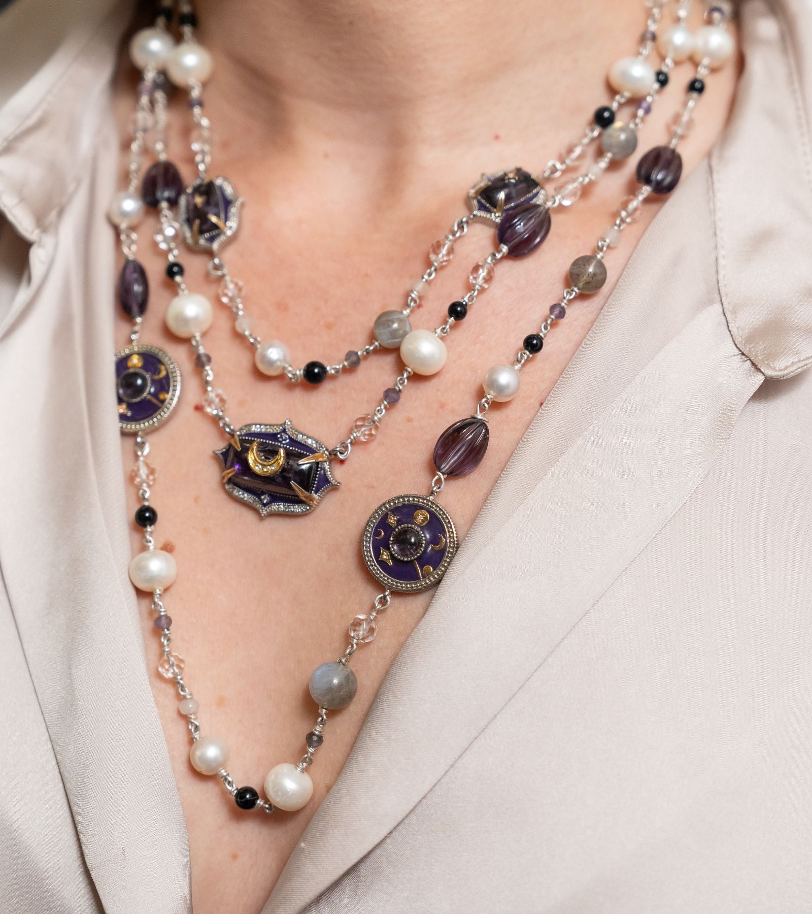 Close-up of the amethyst crystal, Polki diamonds, and purple enamel detailing on the Prive Necklace
