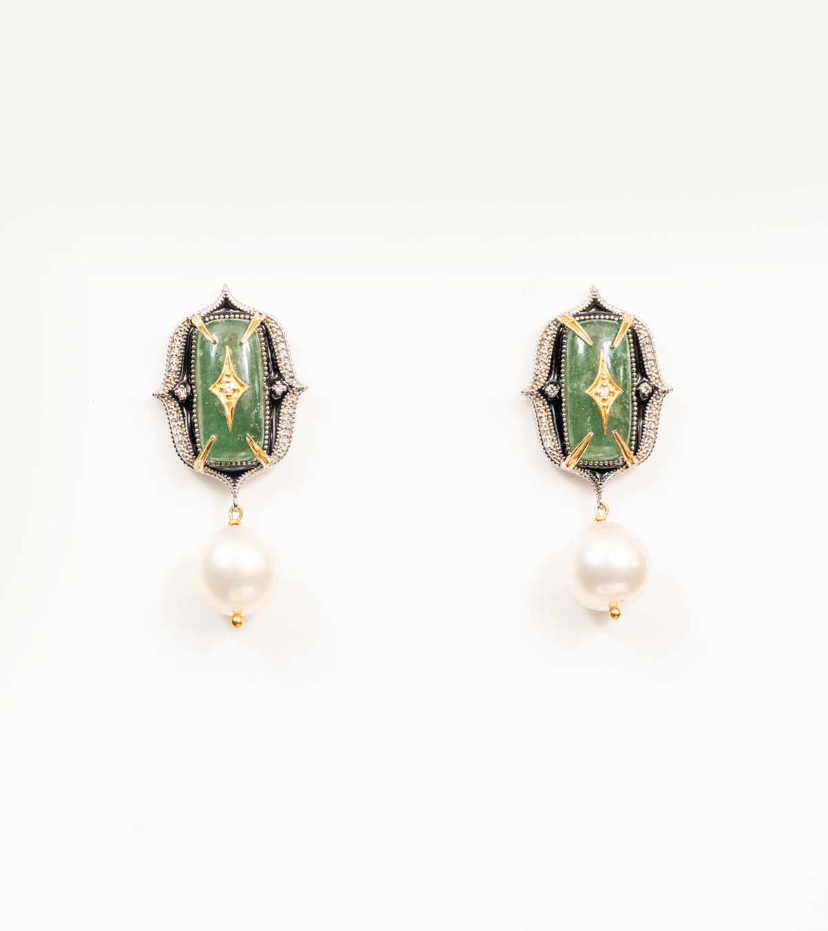 Close-up of the green stone and diamond detailing on the Rewa Earrings' green colorway