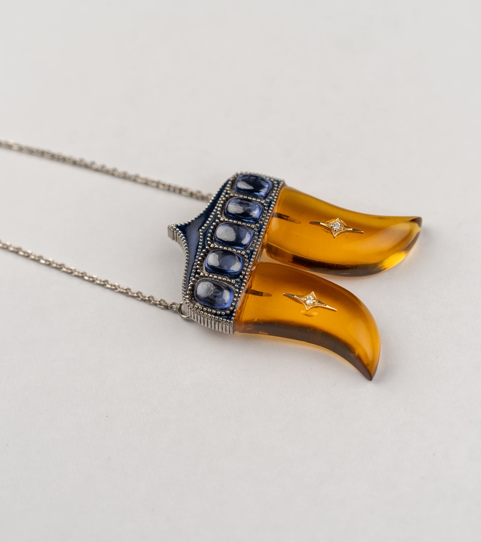 Rio Pendant inspired by the double Vagh Nakh motif, handcrafted in sterling silver with 18K gold accents, natural diamonds, and blue hand-painted enamel