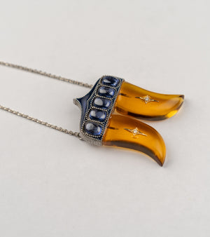 Rio Pendant inspired by the double Vagh Nakh motif, handcrafted in sterling silver with 18K gold accents, natural diamonds, and blue hand-painted enamel