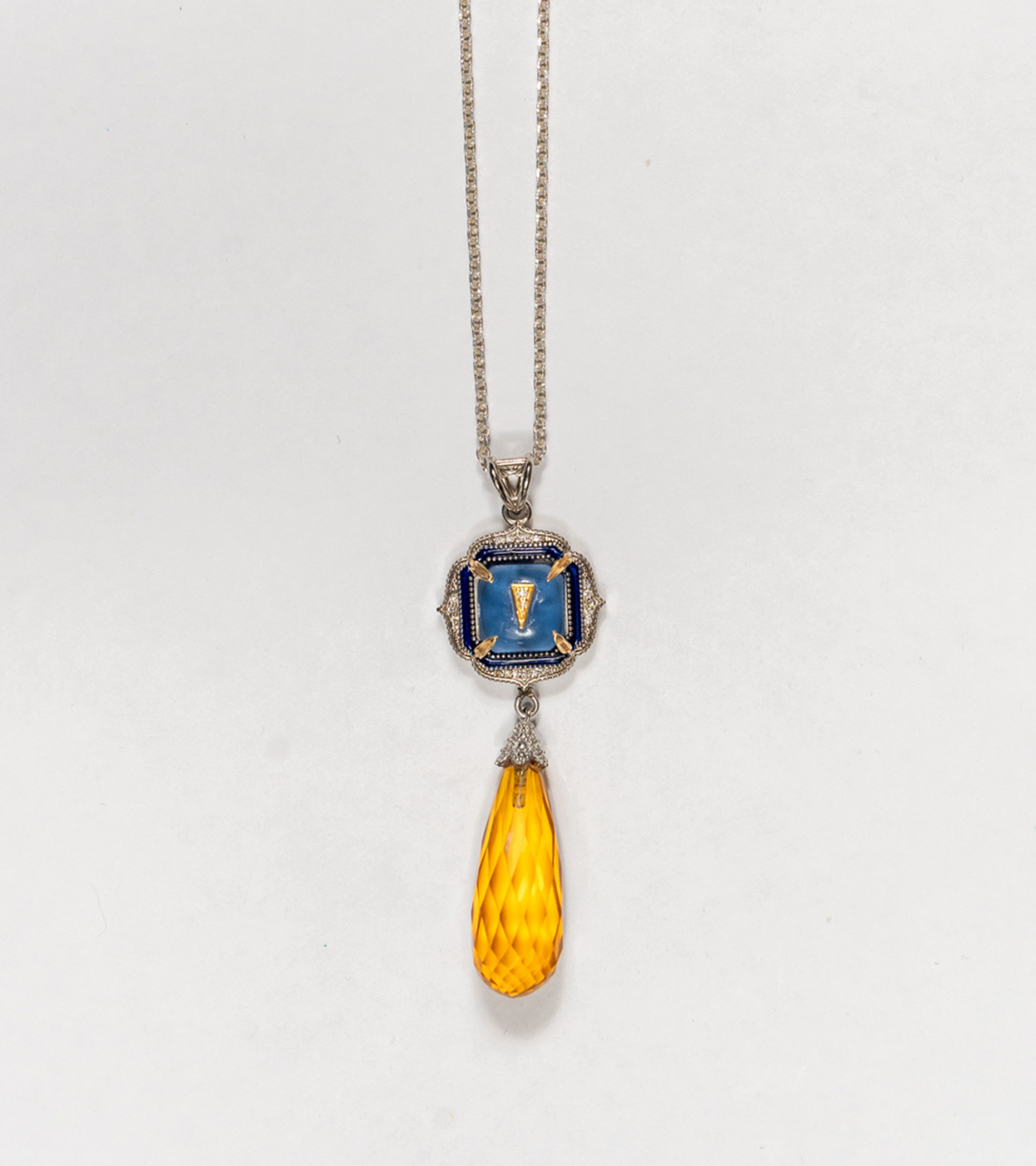Rumi Petit Pendant shown for scale against everyday wear