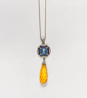 Rumi Petit Pendant shown for scale against everyday wear