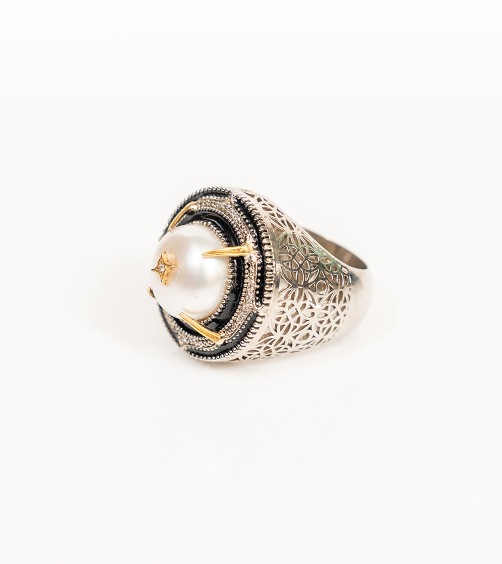 Shakuntala Ring with a South Sea button pearl framed by natural diamonds, sterling silver, and 18K gold