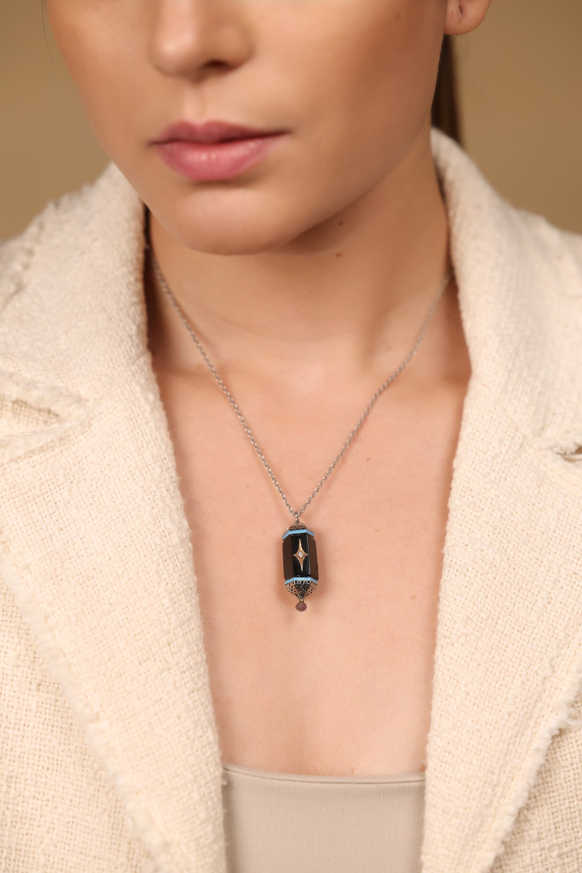 Close-up of the black onyx and diamond detailing on the Sirius Pendant