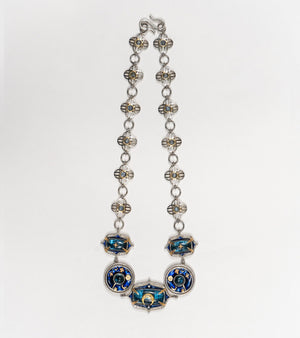 Detail of the hand-painted blue enamel work on the Taskan Choker