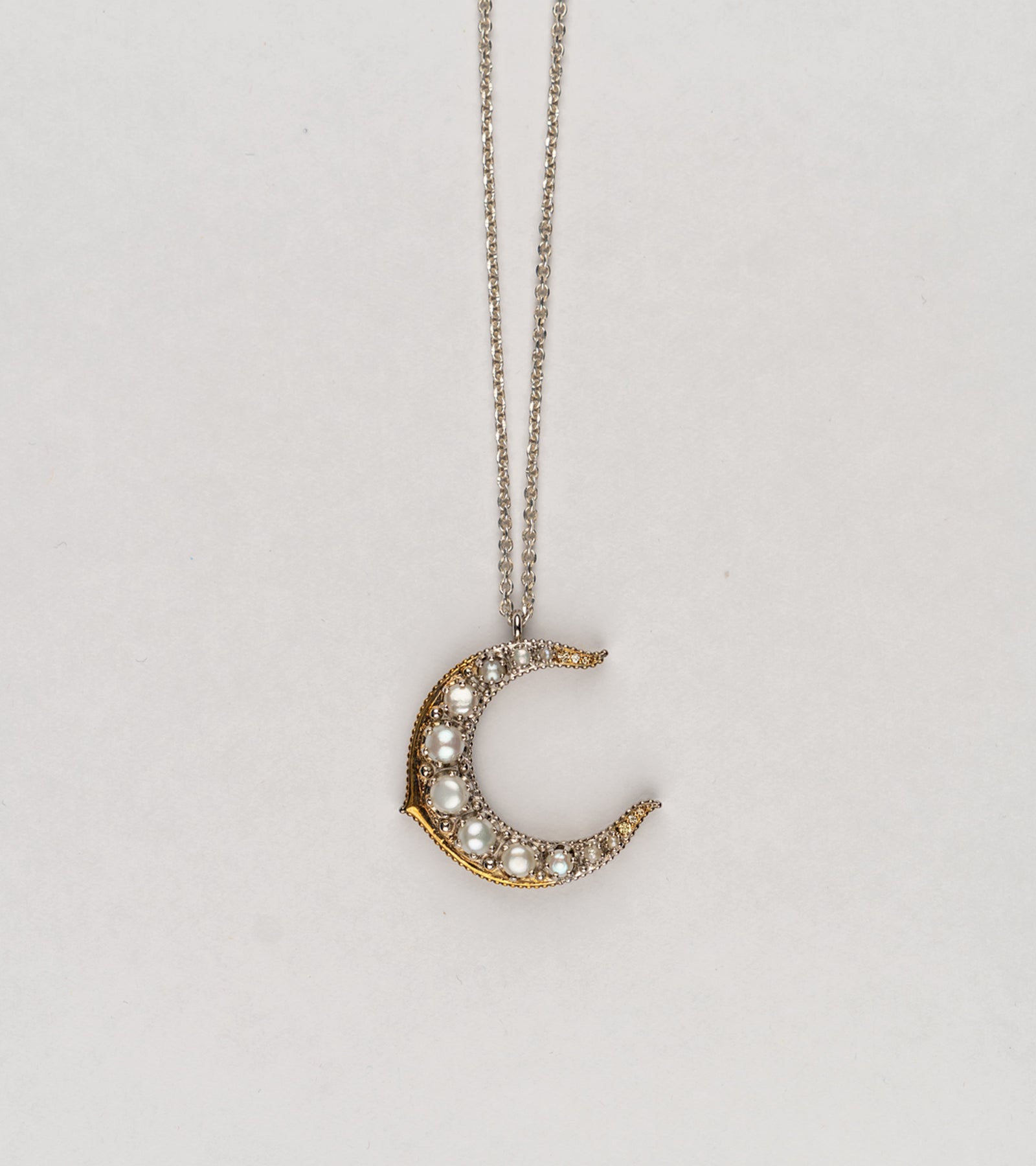 Detail of the Japanese pearls set along the Tsuki Necklace's silver crescent