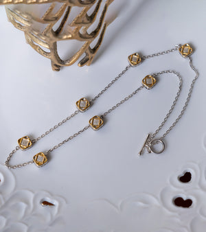 Uma Necklace with cushion-shaped charms set with natural Polki diamonds in 22K Kundan gold, strung on an alternating silver chain