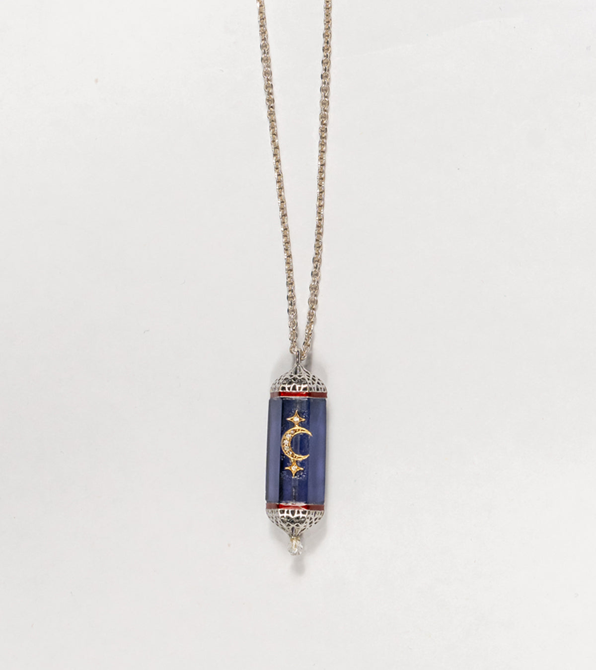 Detail of the hand-painted coral enamel accent on the Vega Pendant