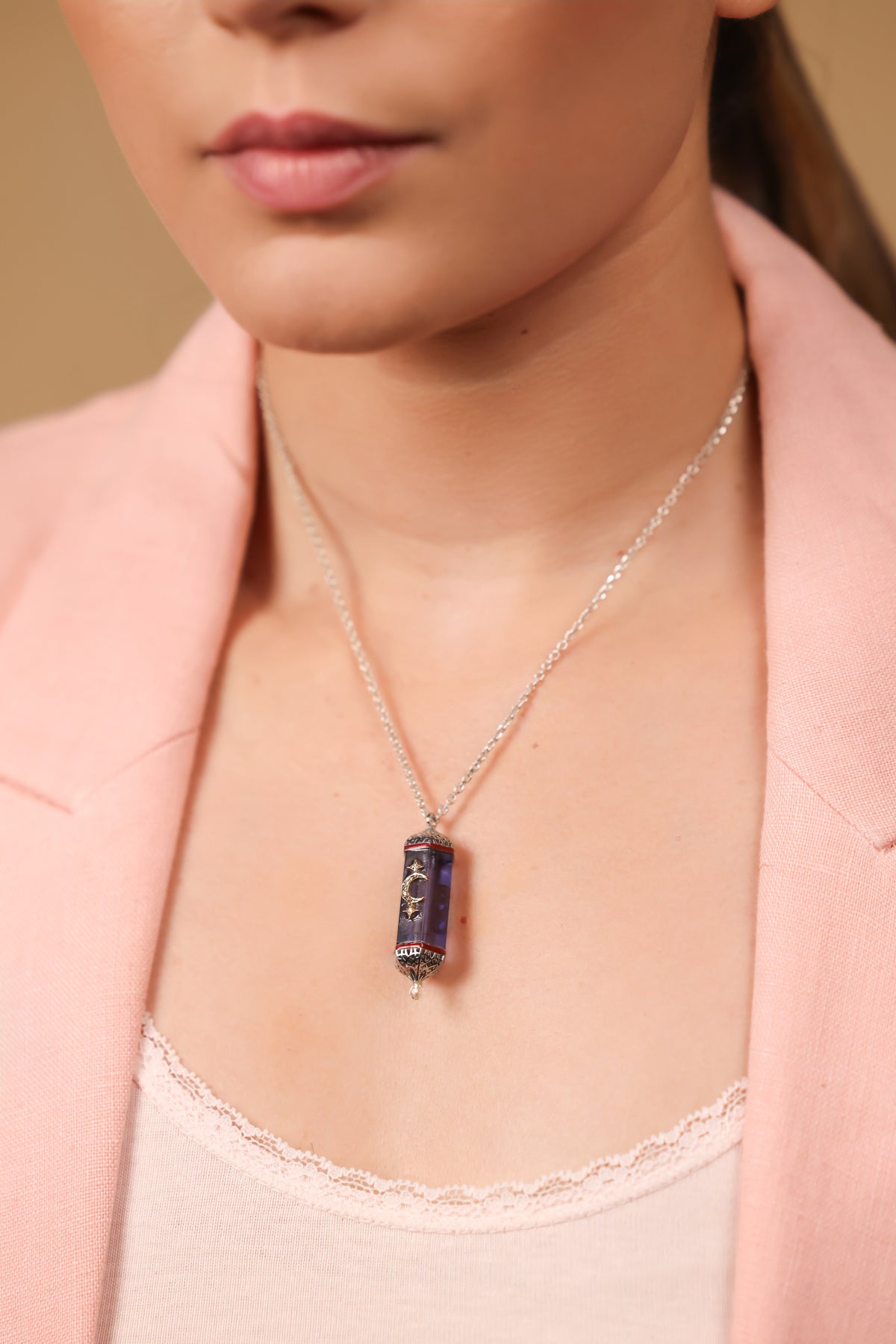 Vega Pendant worn against an elegant neckline, taking the spotlight of the look