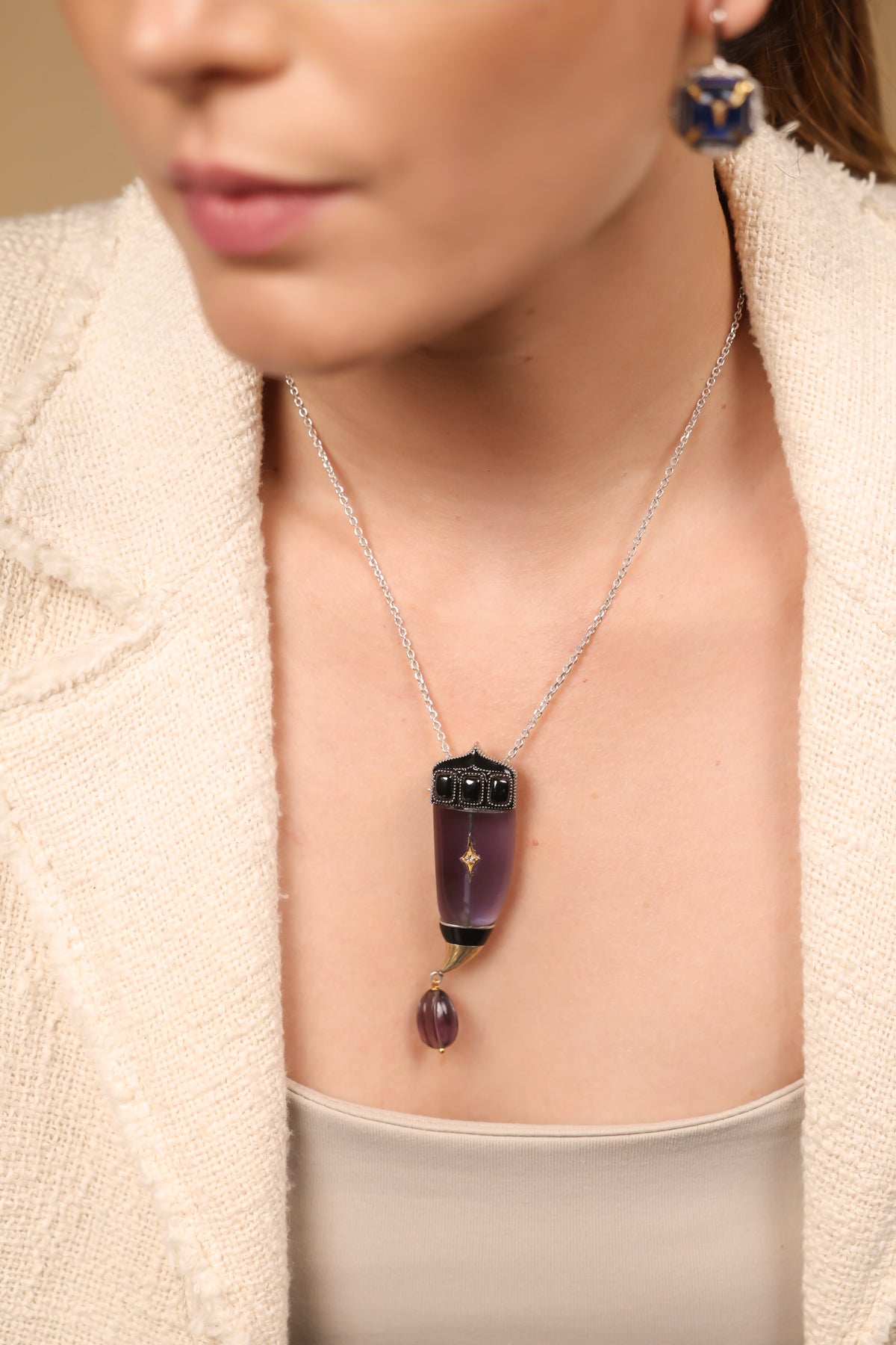 Close-up of the sculptural silhouette and amethyst crystal detailing on the Vita Brooch Pendant