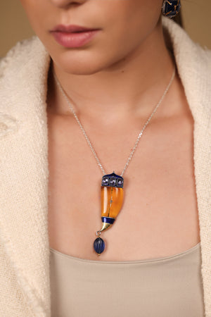 Vita Brooch Pendant worn as a pendant on a long chain with crisp tailoring