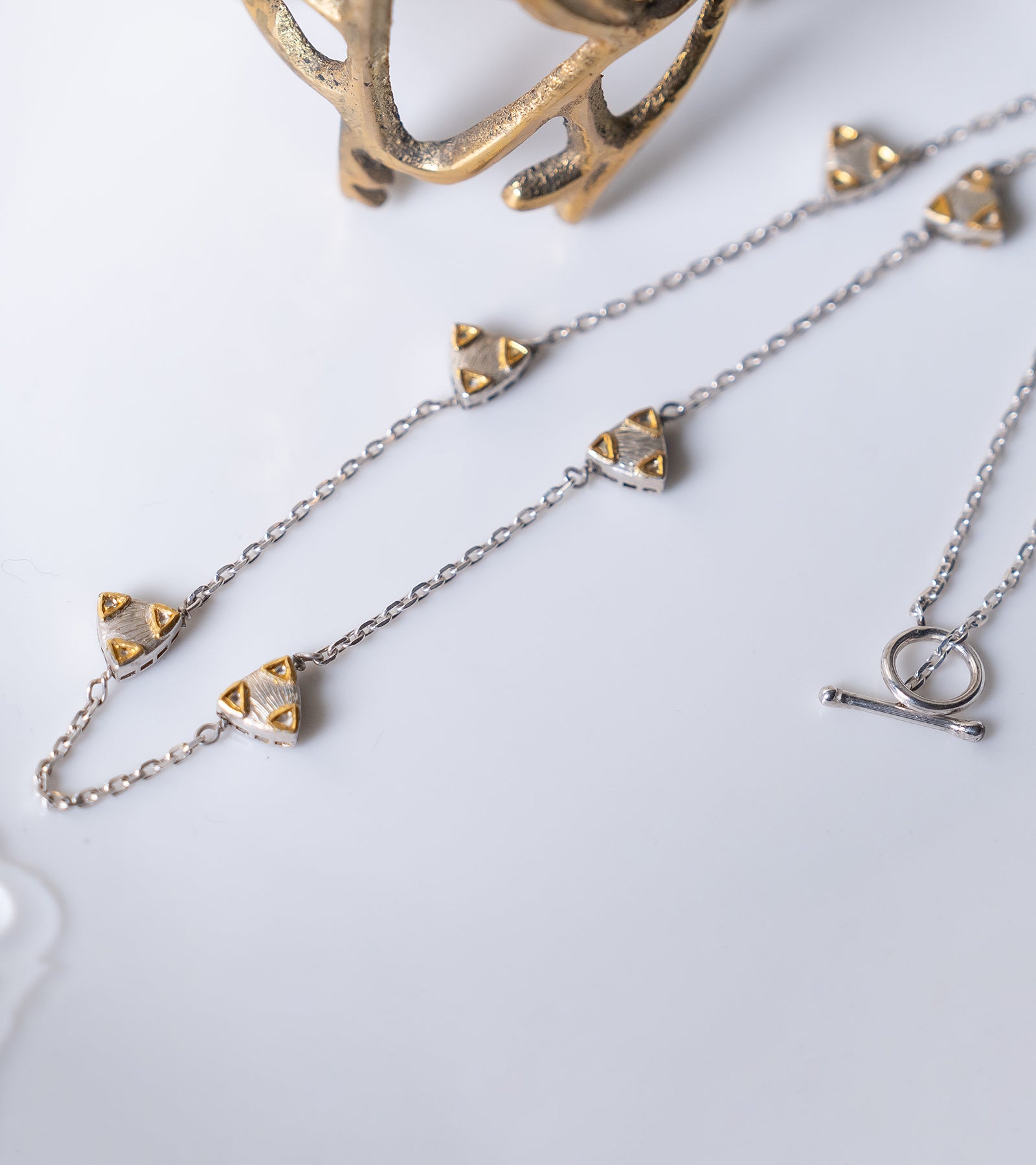 Zee Necklace layered with other necklaces for a personalized day-to-night look