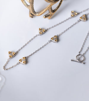 Zee Necklace layered with other necklaces for a personalized day-to-night look