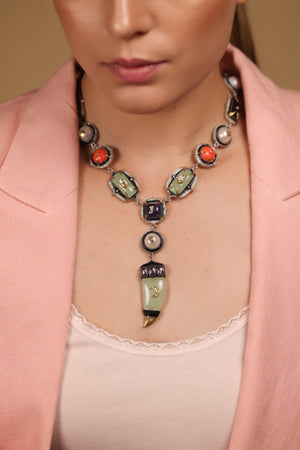 Zuri Necklace worn against a deep, dark silhouette, letting its colours take centre stage